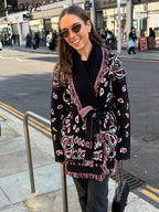 Woman wearing a patterned coat on a city street